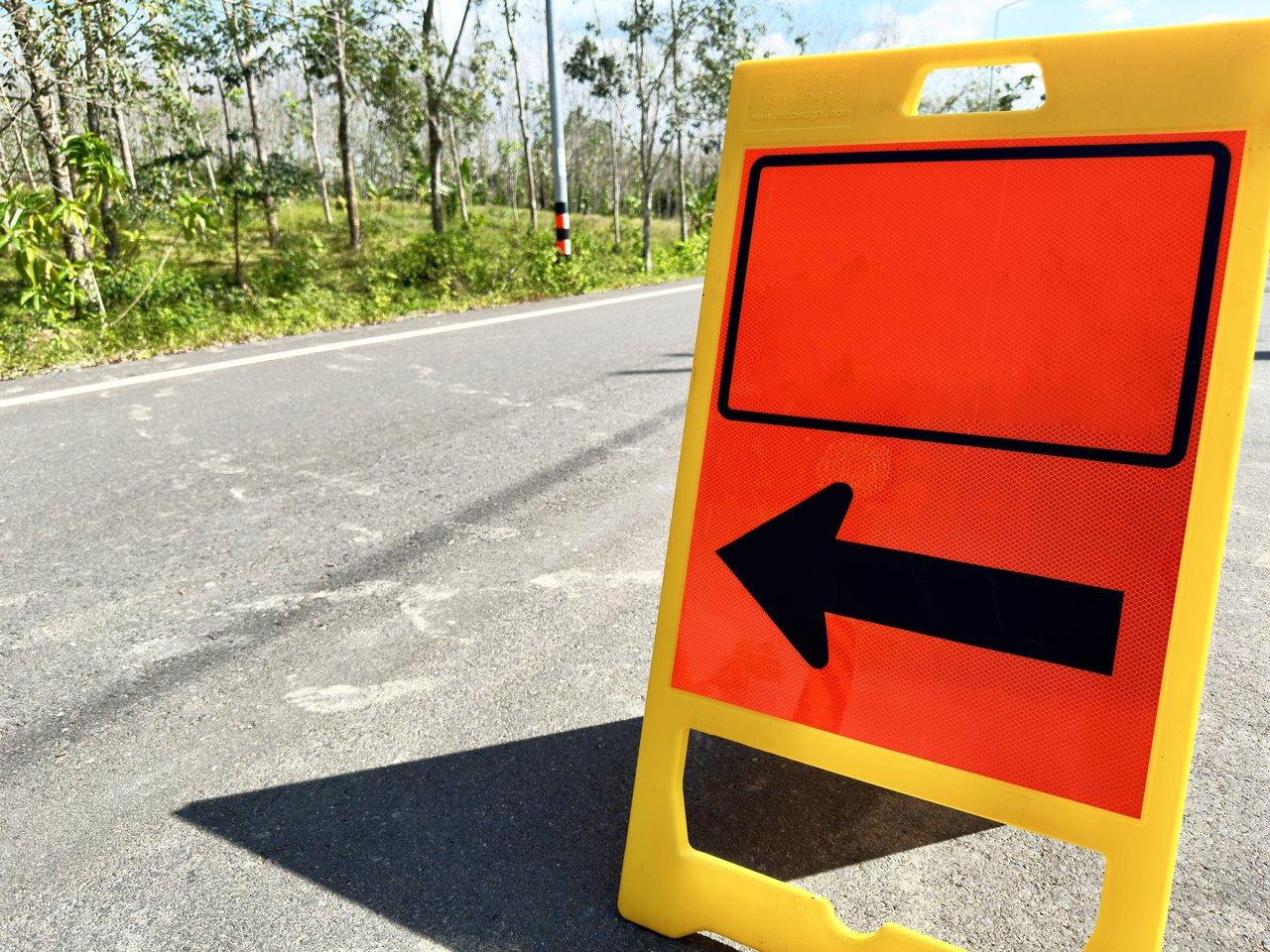 Chaîne de panneaux de signalisation temporaires sur un chantier mobile avec véhicules équipés de dispositifs lumineux.