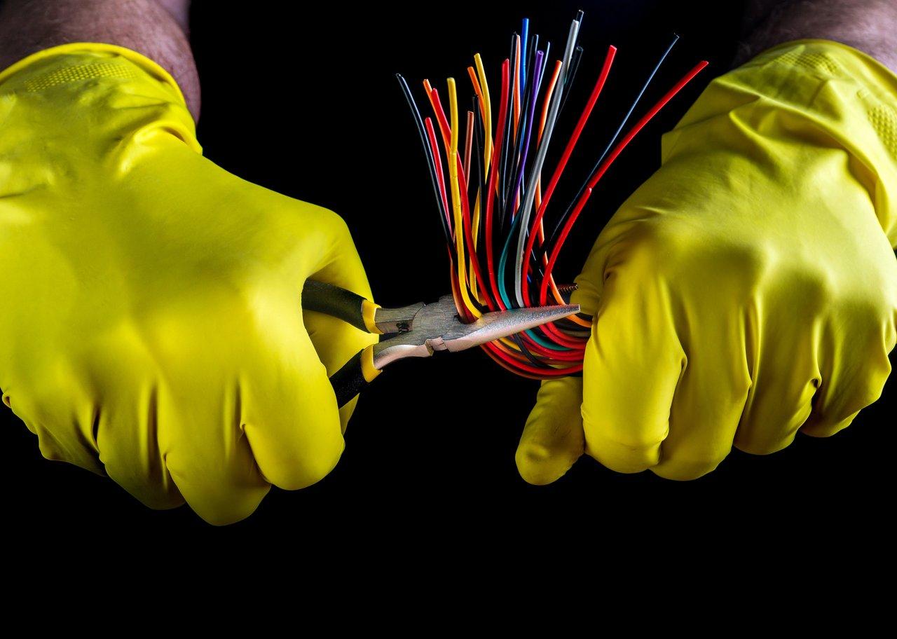 Gant isolant pour électricien offrant une protection efficace face aux chocs électriques lors d'une intervention sur un panneau électrique.