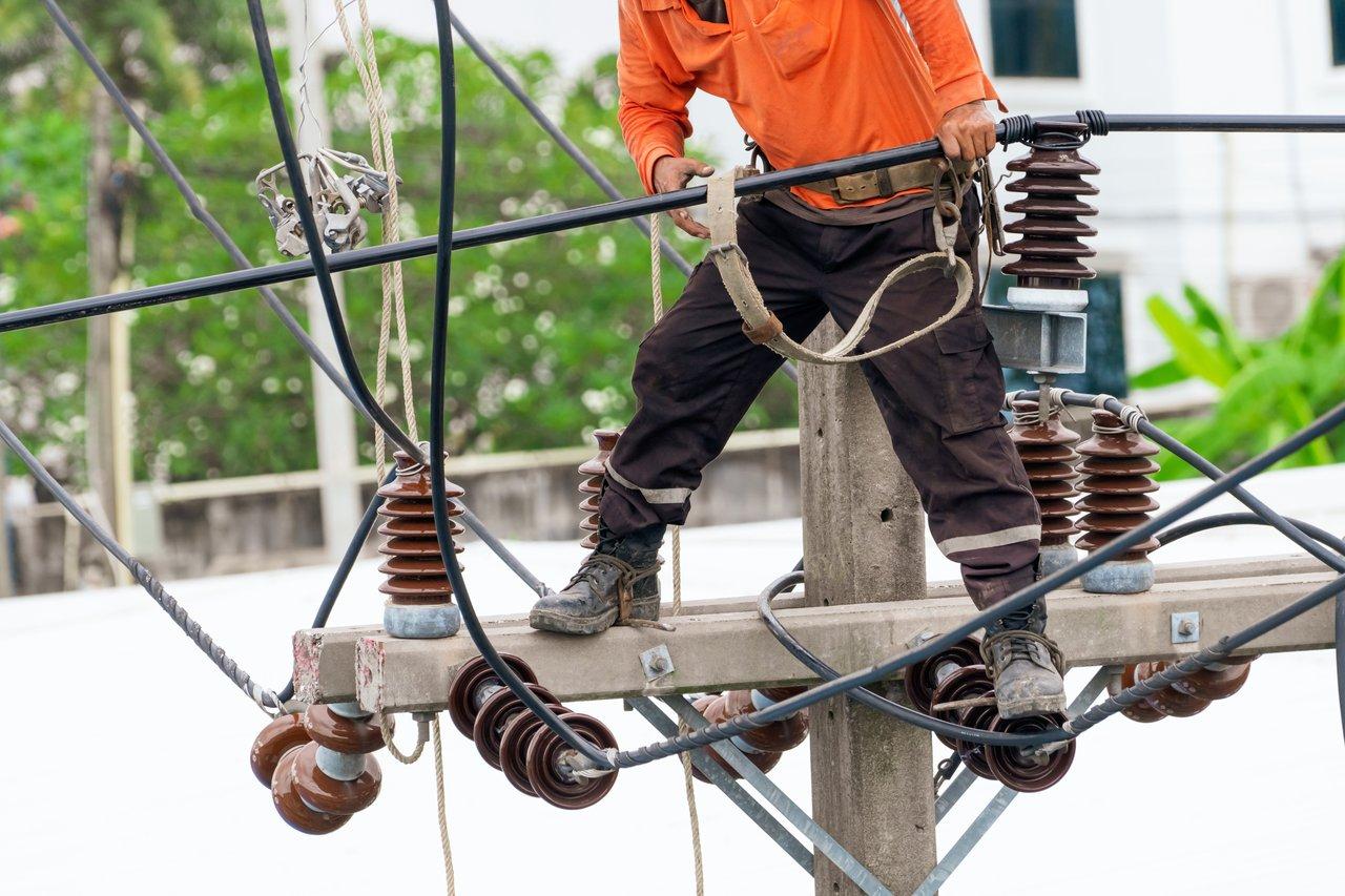 Illustration de la sécurité électrique sur un chantier : signalisation, personnel formé et EPI pour prévenir les risques d’électrocution.